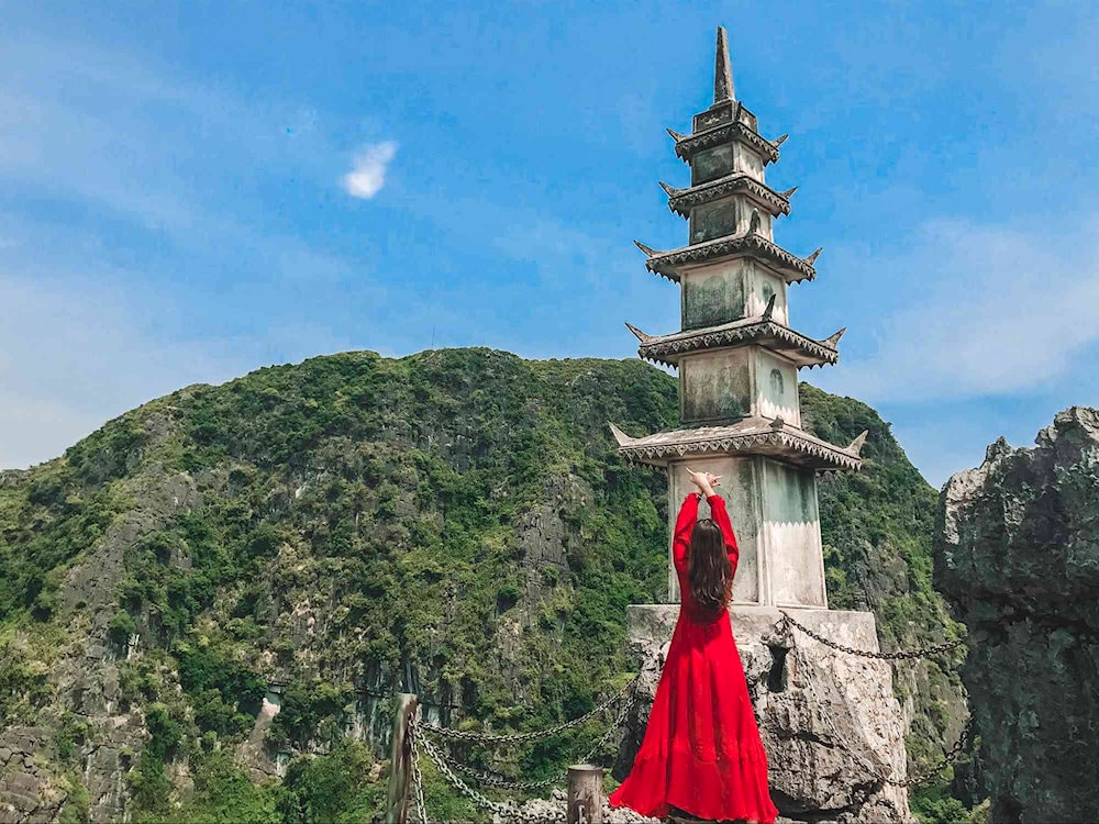Wearing a vibrant maxi dress adds a pop of color to your photos at Mua Caves